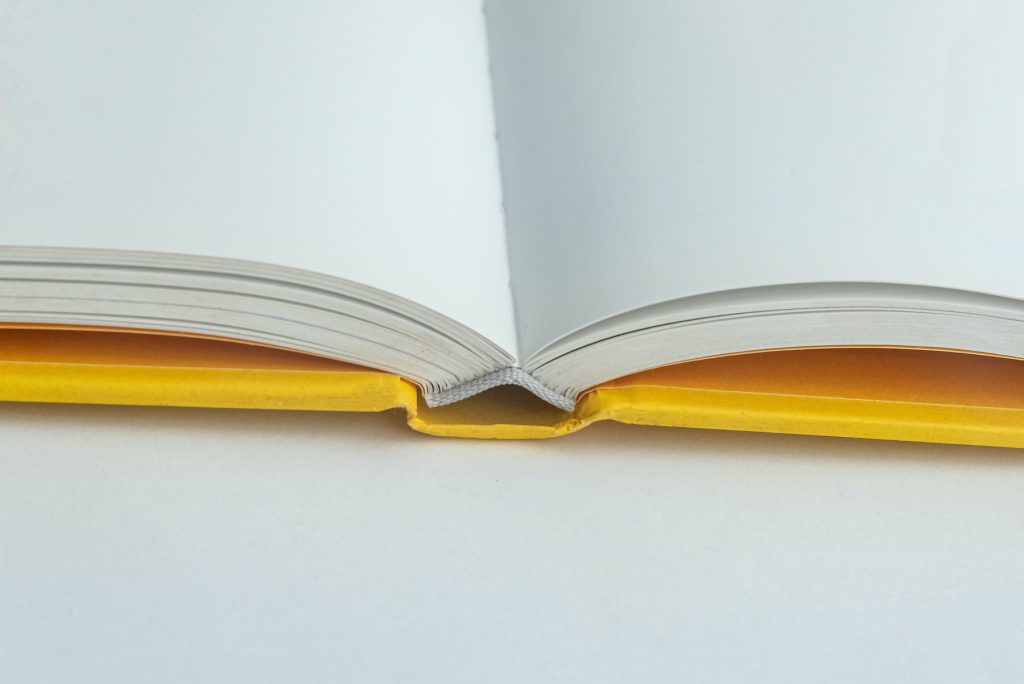 Close-up view of an open hardcover book, emphasizing the precision and durability of high-quality bookbinding techniques.